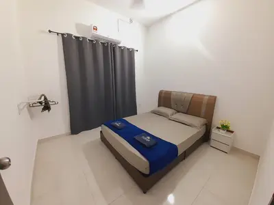 a small bedroom with a bed and a black curtain at Afna Home stay in Kuala Lipis