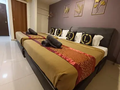 a couple of beds sitting in a room at L Ferringhi Hotel in Batu Ferringhi