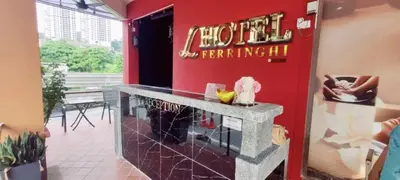 a restaurant with a neon sign on a red wall at L Ferringhi Hotel in Batu Ferringhi