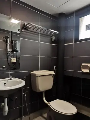 a bathroom with a toilet and a sink at Sabai Sabai Guesthouse in Bayan Lepas in Bayan Lepas
