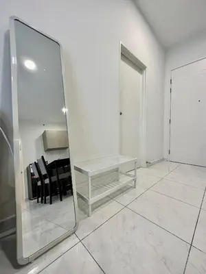 a mirror in a room with a table and chairs at 13A5TheSun#BayanLepas#QueensbayMall#CozyHomestay in Bayan Lepas