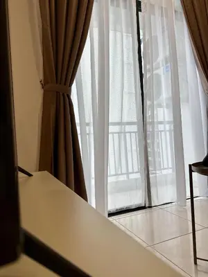 a window with curtains and a table in front of it at 13A5TheSun#BayanLepas#QueensbayMall#CozyHomestay in Bayan Lepas