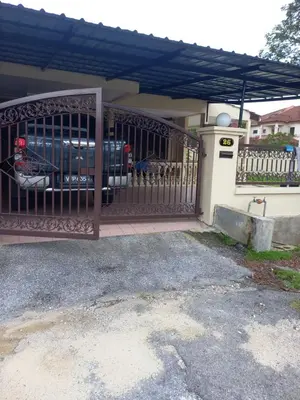 a gate to a house with a car parked behind it at AB Tambun Homestay in Ipoh