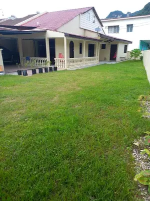 a yard in front of a house with green grass at AB Tambun Homestay in Ipoh
