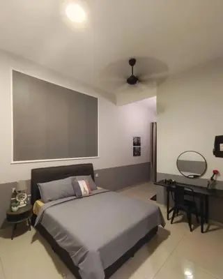 a bedroom with a large bed and a desk at Sweet HOME FOR BIG Family\uff5c11pax+FREE WIFI in Sitiawan