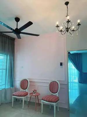 a room with two chairs and a table and a ceiling fan at Sweet HOME FOR BIG Family\uff5c11pax+FREE WIFI in Sitiawan
