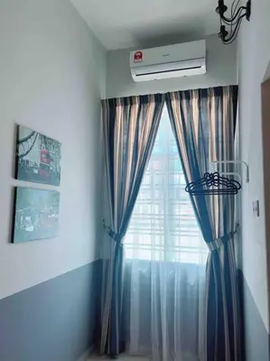 a room with a window with blue curtains at Sweet HOME FOR BIG Family\uff5c11pax+FREE WIFI in Sitiawan