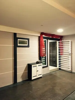 a garage with a door and a red curtain at Lavender house IPOH in Ipoh