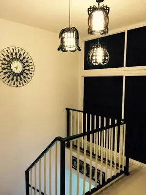 a room with two chandeliers and a crib at Lavender house IPOH in Ipoh