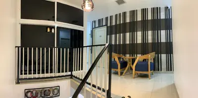 a staircase with a table and chairs in a house at Lavender house IPOH in Ipoh