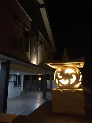a lit up vase sitting outside of a building at night at Lavender house IPOH in Ipoh