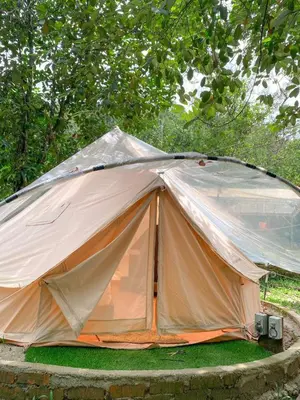 a large tent is set up on the grass at Tingkat Valley in Ipoh