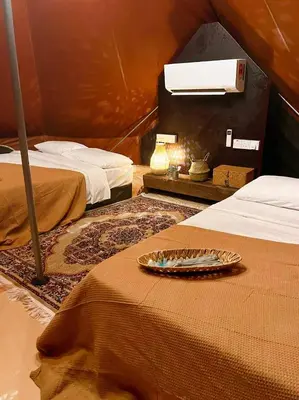 a tent room with two beds and a plate on the bed at Tingkat Valley in Ipoh