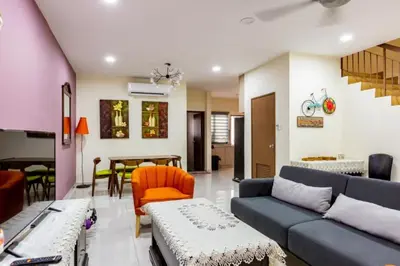 a living room with a couch and a table at HyperTribe -Pangkor Holiday Home in Kampong Sungai Udang