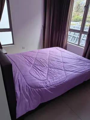 a purple bed in a room with a window at Cold house in Cameron Highlands