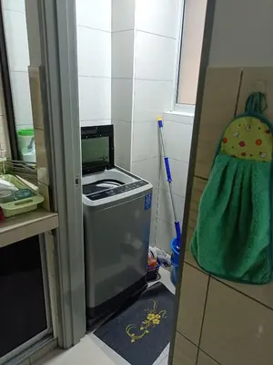 a kitchen with a washing machine and a broom at Cold house in Cameron Highlands