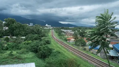 a view of a city with a train track and trees at Beverly Hotel in Taiping