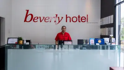 a man standing in front of a beverley hotel sign at Beverly Hotel in Taiping