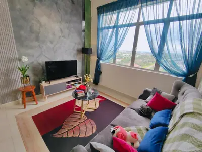 a living room with a couch and a large window at Desig Classic Falim by irainbow in Ipoh