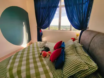 a bedroom with a bed with pillows and a window at Desig Classic Falim by irainbow in Ipoh