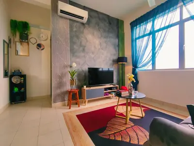 a living room with a couch and a tv at Desig Classic Falim by irainbow in Ipoh