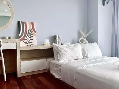 a bedroom with a bed and a table with a mirror at SUNRISE GURNEY FULLSEAVIEW LUXURY 2ROOM SUITE 8PAX in Kampong Makam