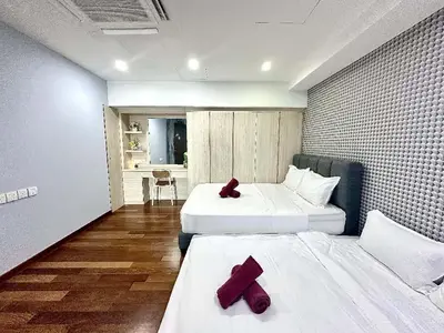 two beds in a room with red pillows on them at SUNRISE GURNEY FULLSEAVIEW LUXURY 2ROOM SUITE 8PAX in Kampong Makam