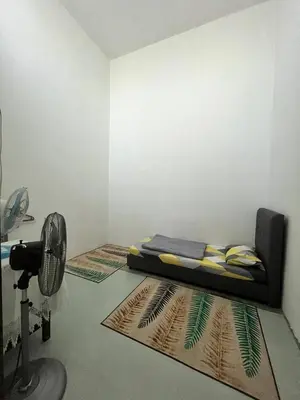 a room with a bed and a camera on the floor at Tapak 173 by Sutera Hōmes in Sungai Petani