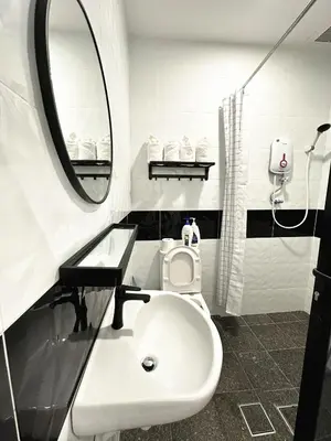 a white bathroom with a sink and a mirror at PM153 LandedHouse Modern Airport in Bayan Lepas