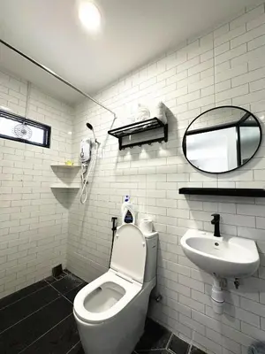 a white bathroom with a toilet and a sink at PM153 LandedHouse Modern Airport in Bayan Lepas