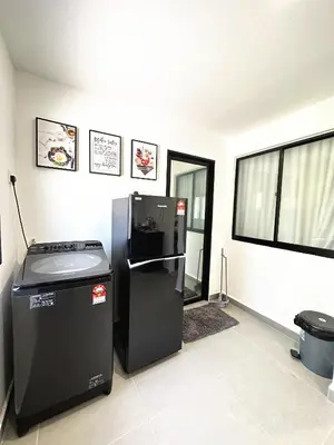 a room with a black refrigerator next to a window at PM153 LandedHouse Modern Airport in Bayan Lepas