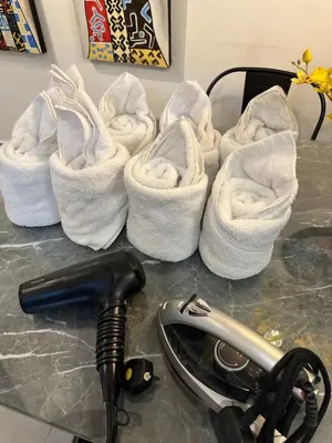 a group of white towels sitting on a counter at PM153 LandedHouse Modern Airport in Bayan Lepas