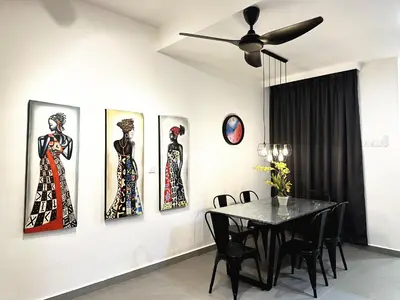 a dining room with four pictures of women on the wall at PM153 LandedHouse Modern Airport in Bayan Lepas