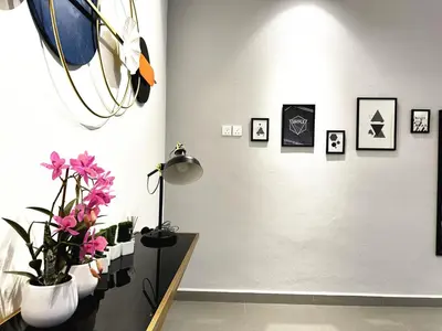 a room with flowers and pictures on the wall at PM153 LandedHouse Modern Airport in Bayan Lepas