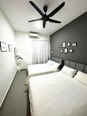 two beds in a room with a ceiling fan at PM153 LandedHouse Modern Airport in Bayan Lepas