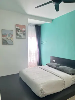 a bedroom with a large bed with a ceiling fan at Emerald Avenue Cozy 3R3B Apartment 716 in Brinchang