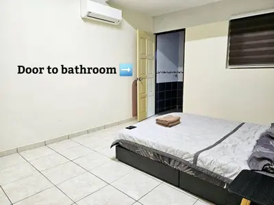 a bedroom with a bed and a sign that says door to bathroom at Air-home M3 Simpang near Aulong Econsave, 4BR, 10pax, Netflix in Taiping
