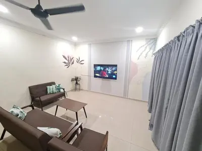 a living room with two chairs and a tv on a wall at Air-home M3 Simpang near Aulong Econsave, 4BR, 10pax, Netflix in Taiping