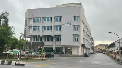 a building with a car parked in front of it at Legend Inn Taiping in Taiping