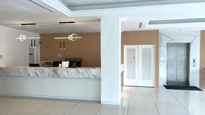 a lobby with a marble counter in a building at Legend Inn Taiping in Taiping