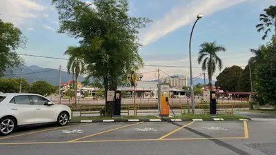 a white car parked in a parking lot at Legend Inn Taiping in Taiping
