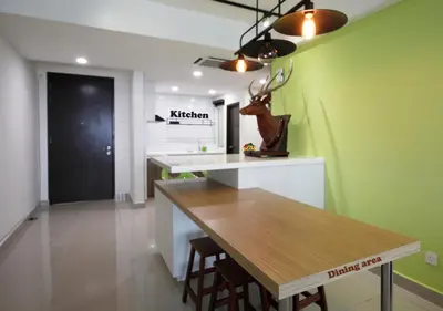 a dining room with a table and a green wall at H2H - Cherry house Majestic in Ipoh
