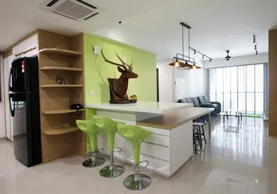 a kitchen with a counter with green walls and green stools at H2H - Cherry house Majestic in Ipoh
