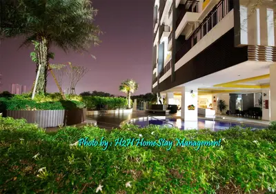 a building with a swimming pool in front of it at H2H - Cherry house Majestic in Ipoh
