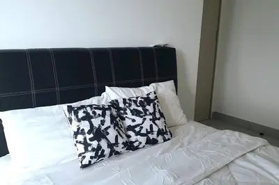 a bed with two pillows on top of it at Southbay Seaview Condo A10 #10minQueensbay #15minSPICE in Bayan Lepas
