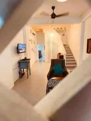 a view of a living room with a couch and stairs at Georgetown Kyash House 23 in George Town
