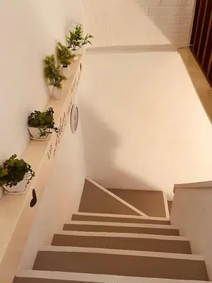a staircase in a building with potted plants at Georgetown Kyash House 23 in George Town