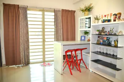 a kitchen with red stools at a white counter at Near Gurney 3-Storey Event Hse by Felice Homestay in Tanjong Tokong