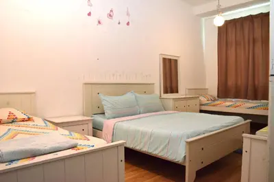 a bedroom with two beds and a mirror at Near Gurney 3-Storey Event Hse by Felice Homestay in Tanjong Tokong