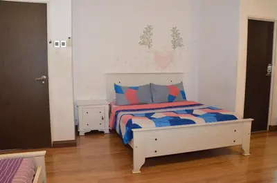 a bedroom with a white bed with blue and red pillows at Near Gurney 3-Storey Event Hse by Felice Homestay in Tanjong Tokong